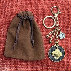 QUATREFOIL BAG CHARM, Black and Gold Tone Charms